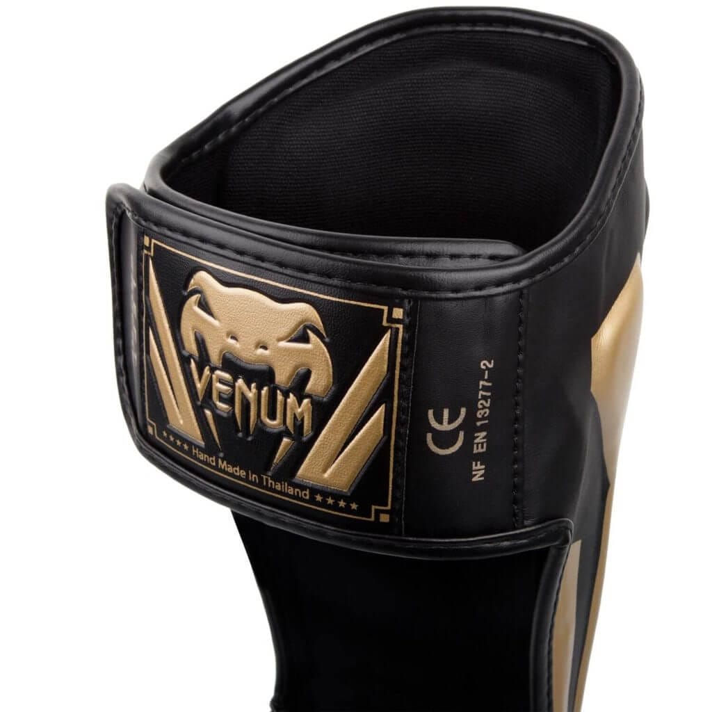 Paratibie Venum Elite Nero/Oro per Muay Thai, Kickboxing e MMA