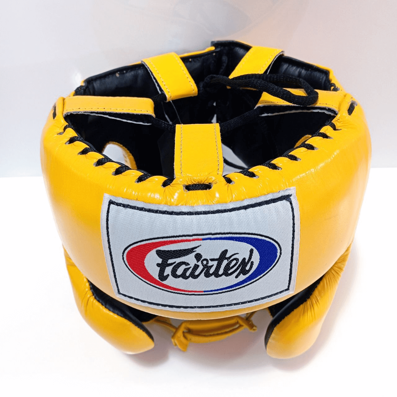 Caschetto Sparring Fairtex Mexican Style Giallo con Parazigomi, senza paramento, per allenamenti di Pugilato, Muay Thai, Kickboxing ed MMA. Dotato di imbottitura extra sulle zone d'impatto come zigomi, fronte ed orecchie, è realizzati con la migliore pelle bovina sul mercato per una durata senza eguali.